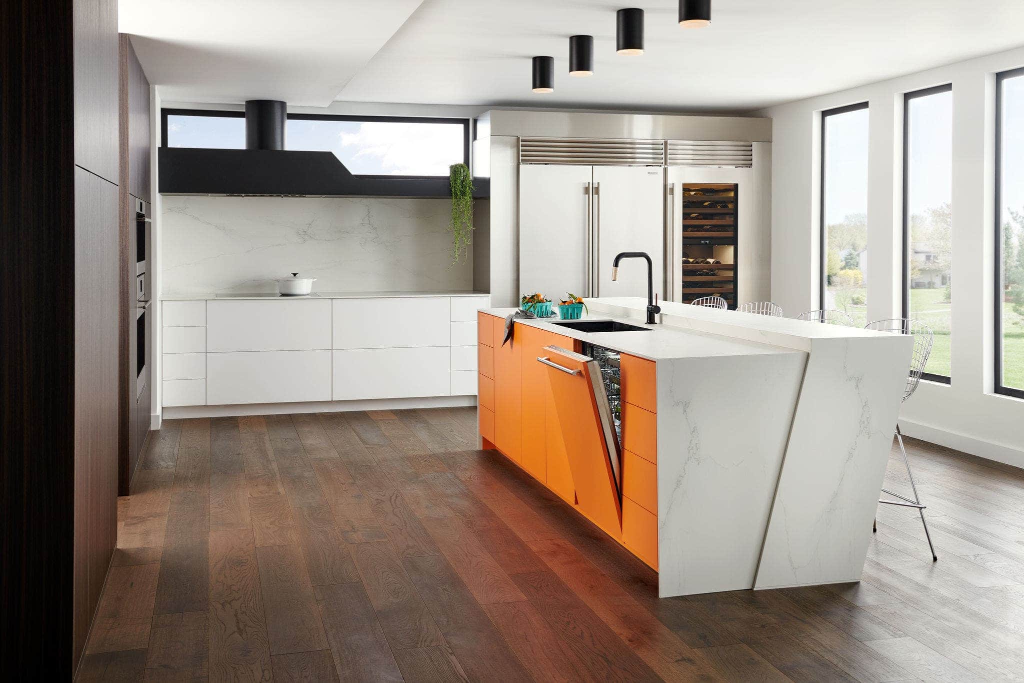 A Cove dishwasher in an orange island with a white stone waterfall top