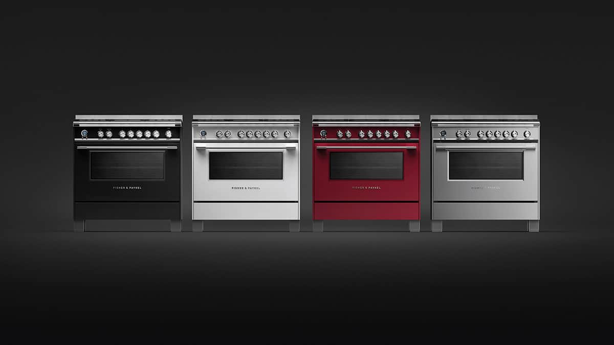 Four Fisher & Paykel Series 9 Classic dual fuel ranges side by side in black, white, red and stainless steel on a dark ground