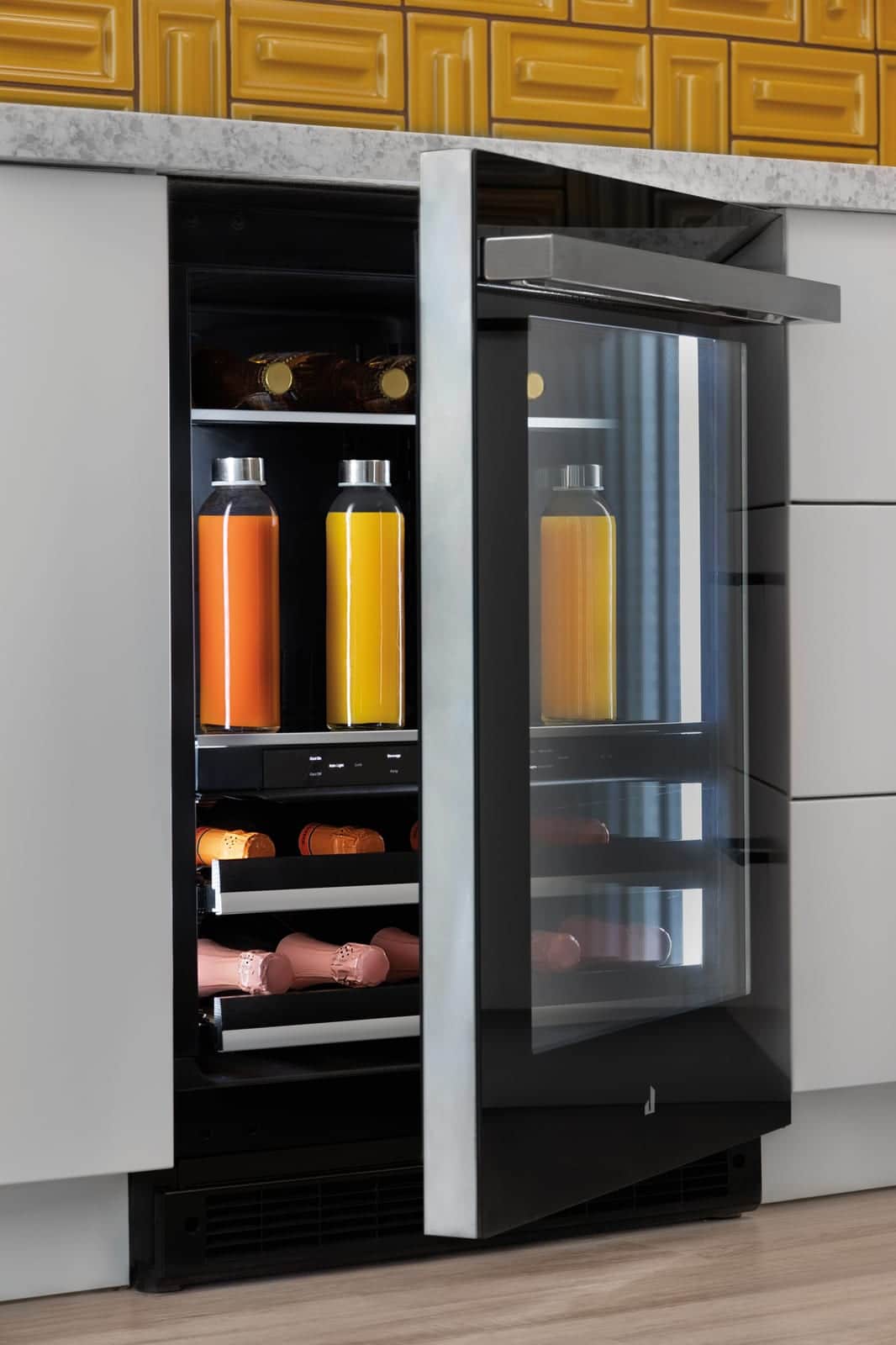An open glass-door JennAir beverage centre stocked with bottles