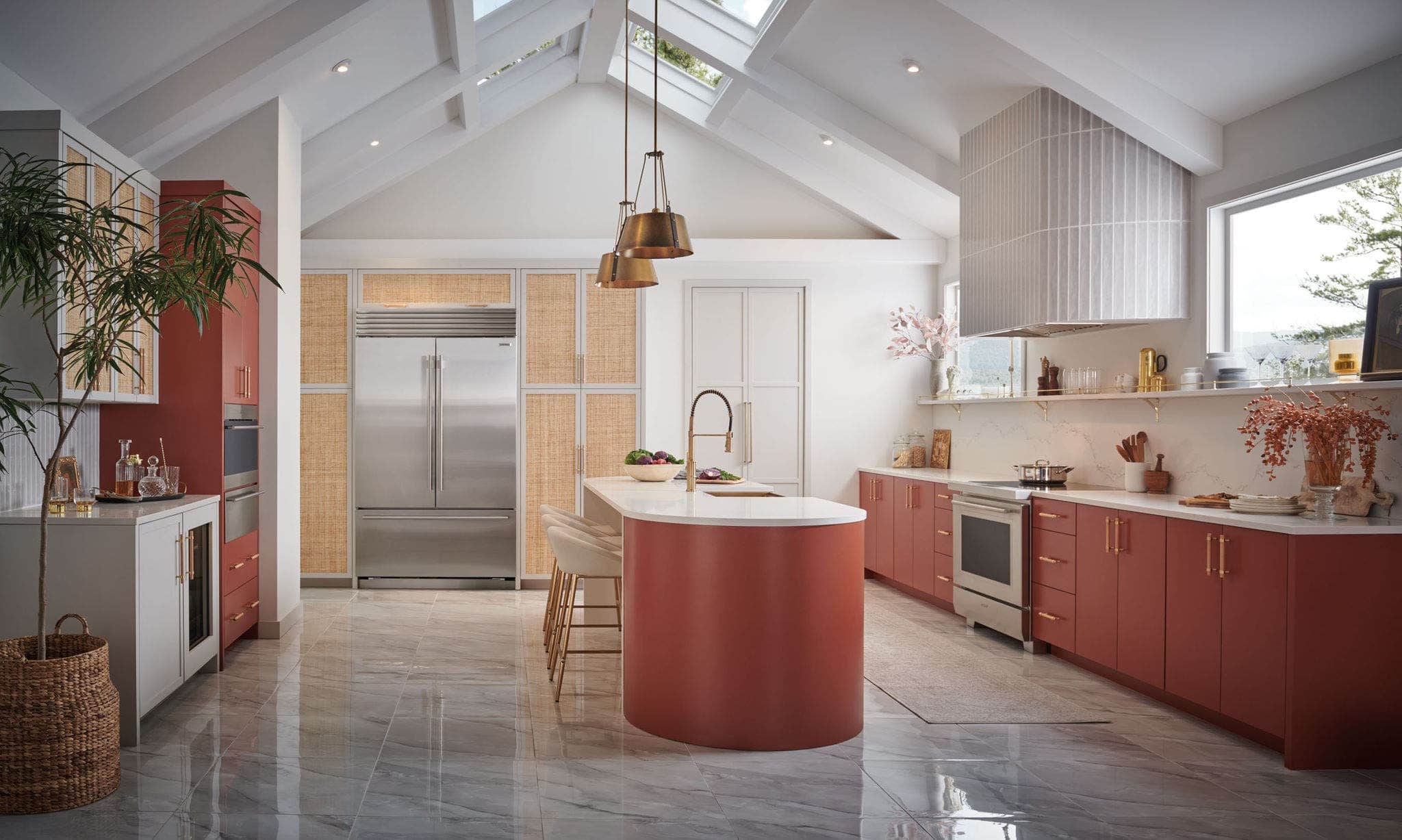 Sub-Zero refrigerator and freezer columns beside a curved terracotta island under a vaulted ceiling