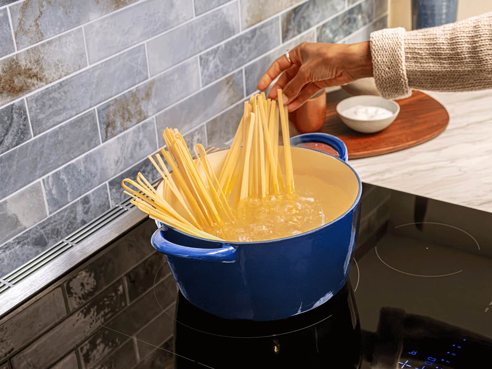 Pasta going into a boiling pot on a Thermador induction cooktop