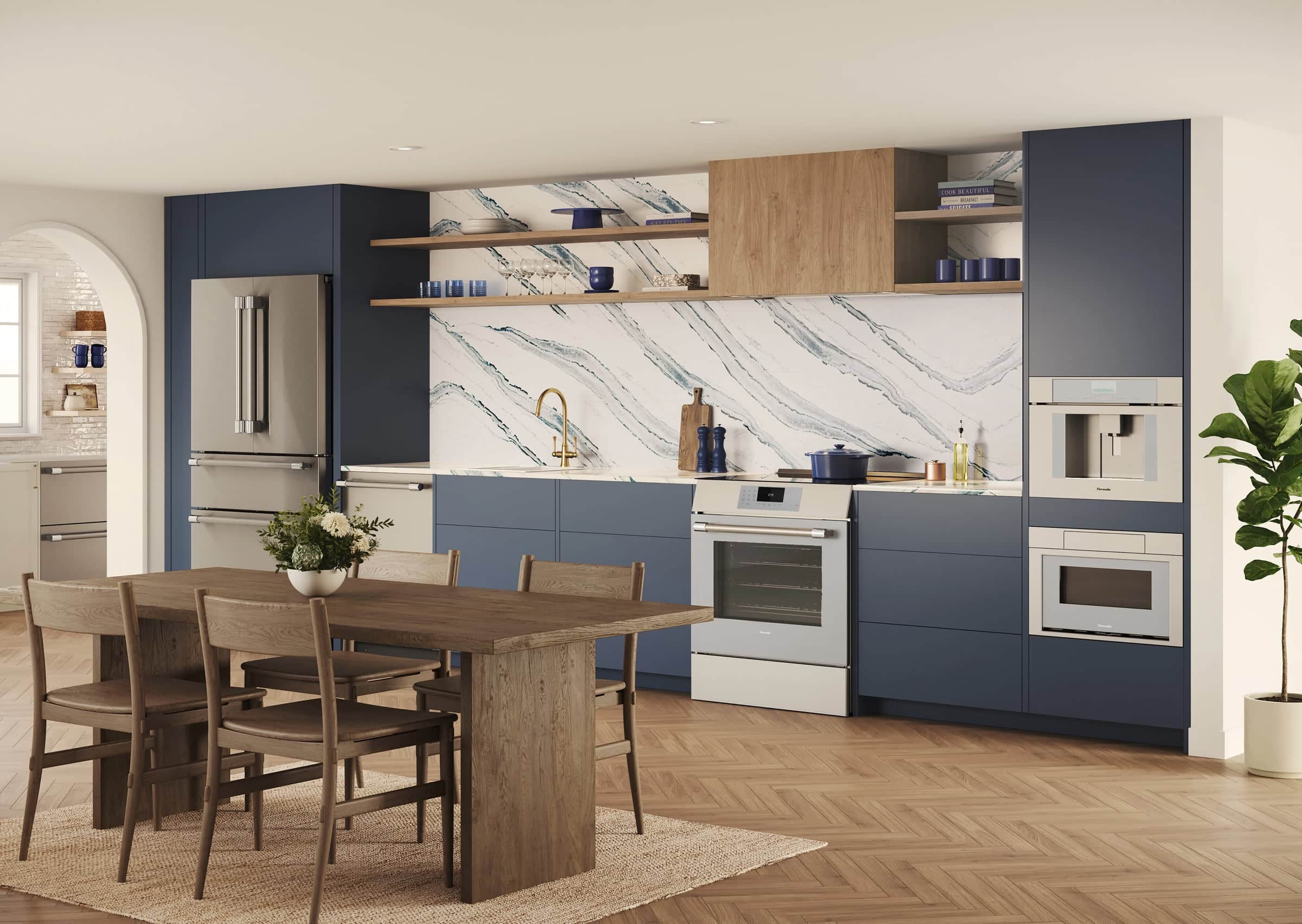 A navy kitchen with a marble-veined slab backsplash and open oak shelves, a stainless Thermador range set below a cabinetry-integrated hood, with a wall oven and coffee system alongside and an oak dining table in front