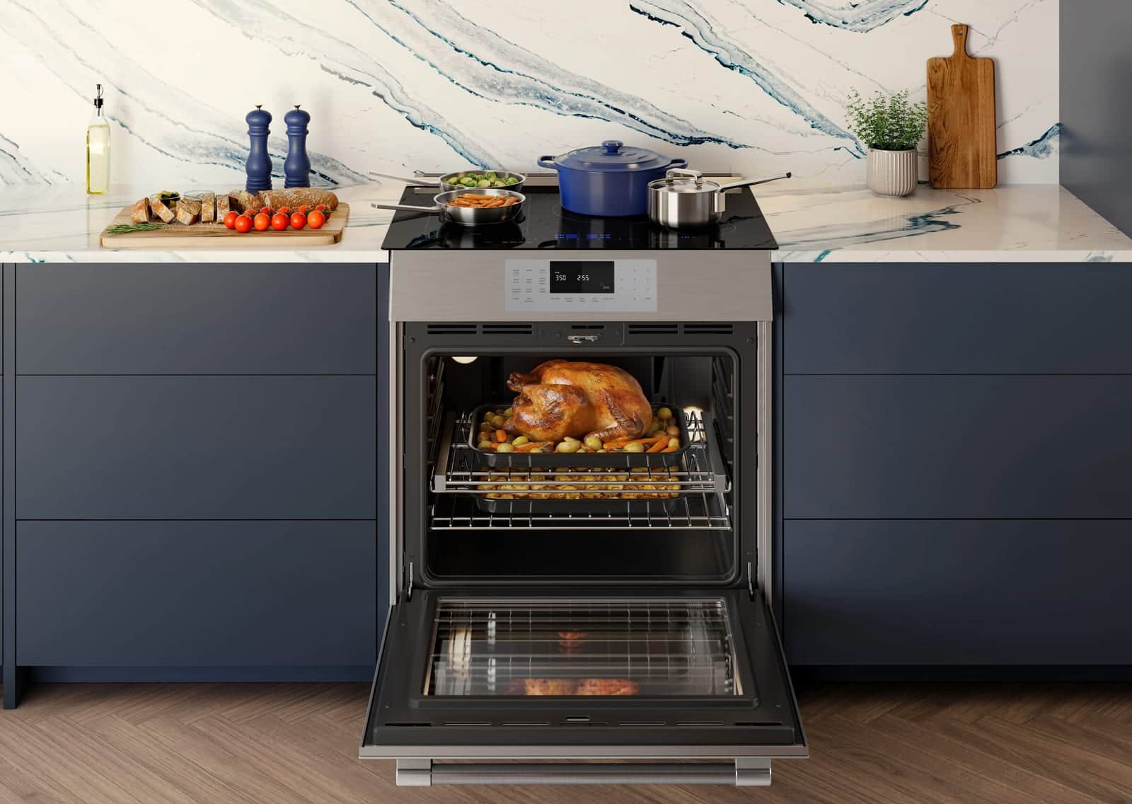 A Thermador range with the oven open on a roast in a navy kitchen with a marble backsplash