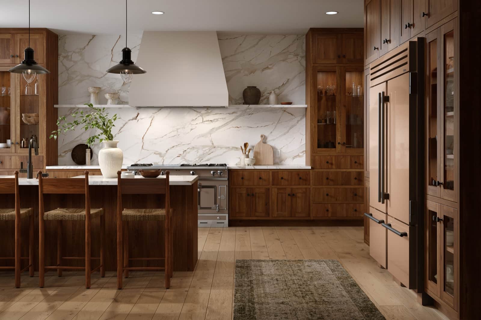 Champagne-finish True Residential refrigerator column in a dark walnut kitchen with a marble slab backsplash and hood